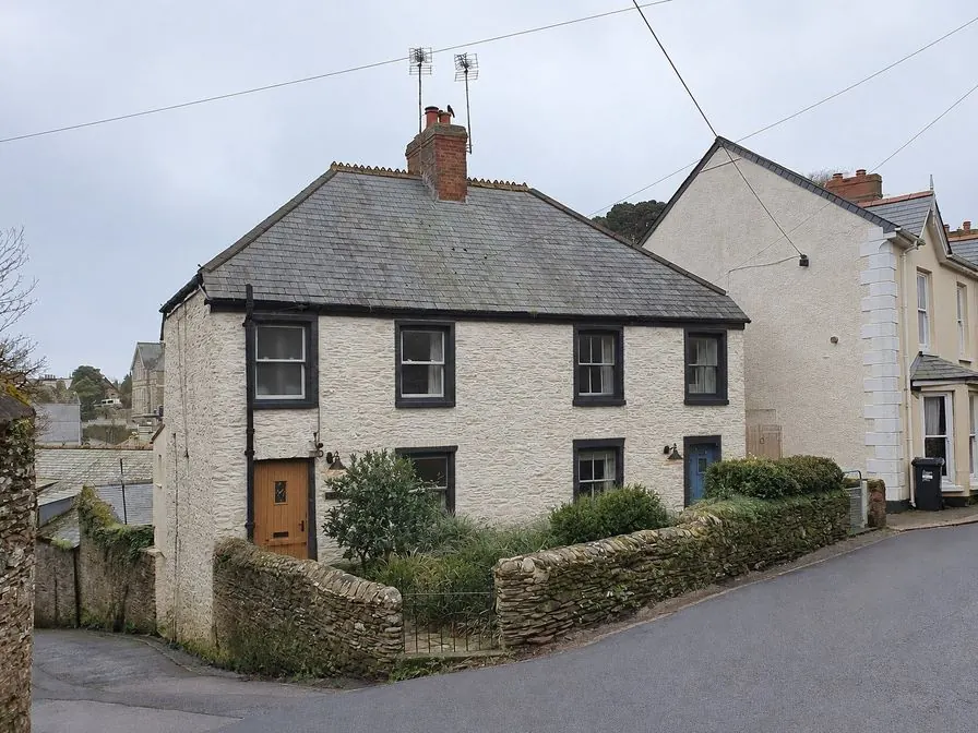 The same houses as an AI concept with limewashed stone, charcoal frames and an oak door
