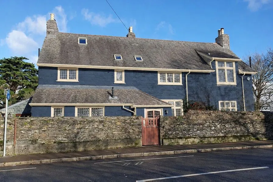 The same house as an AI concept with navy painted walls and cream trim